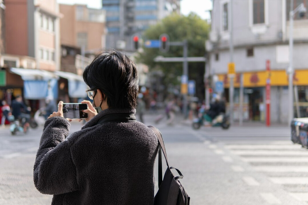 Photographer taking a picture of a street scene
